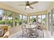 Bright Florida room with dining set, exercise bike and views of the yard at 3750 Raspberry Ct, The Villages, FL 32163