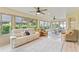 Light-filled Florida room featuring large windows and comfortable seating at 3750 Raspberry Ct, The Villages, FL 32163