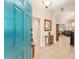 Foyer with a blue front door and tiled flooring, leading to the living spaces at 3750 Raspberry Ct, The Villages, FL 32163