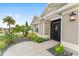 Inviting home exterior with a manicured garden and a secure front door with storm door at 3750 Raspberry Ct, The Villages, FL 32163