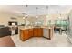 Open kitchen with granite countertops, stainless steel appliances and seamless flow to dining and living areas at 3750 Raspberry Ct, The Villages, FL 32163