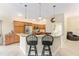 Stylish eat-in kitchen featuring modern stainless steel appliances, breakfast bar, and pendant lighting at 3750 Raspberry Ct, The Villages, FL 32163