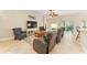 Inviting living room with comfortable seating, a ceiling fan, and sliding doors to the lanai at 3750 Raspberry Ct, The Villages, FL 32163