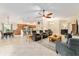 Open concept living room with an eat-in kitchen, neutral tile, and an abundance of seating at 3750 Raspberry Ct, The Villages, FL 32163