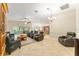 Spacious living room with neutral tile floors, ceiling fan, and plenty of comfortable seating at 3750 Raspberry Ct, The Villages, FL 32163