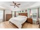 Spacious main bedroom with a tray ceiling, ceiling fan and large windows at 3750 Raspberry Ct, The Villages, FL 32163