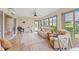 Spacious sunroom with sliding glass doors to the backyard, seating, and lots of windows at 3750 Raspberry Ct, The Villages, FL 32163