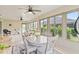 Bright sunroom with lots of windows, light wood floors, ceiling fans, and an adjacent sitting room at 3750 Raspberry Ct, The Villages, FL 32163