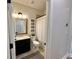 Cozy bathroom with rustic decor, including a wooden-framed mirror and charming wall art at 384 Summer Squall Rd, Davenport, FL 33837