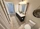 Inviting bathroom with double sinks, a framed mirror, and a decorative round shelf for added charm at 384 Summer Squall Rd, Davenport, FL 33837