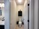 Half bath with toilet and vanity, cabinet with decor and tile flooring at 384 Summer Squall Rd, Davenport, FL 33837
