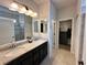 Bathroom features granite countertops, dual sinks, and walk-in shower at 384 Summer Squall Rd, Davenport, FL 33837