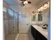 Bathroom features granite countertops, dual sinks, and walk-in shower at 384 Summer Squall Rd, Davenport, FL 33837