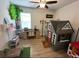 A creative bedroom is decorated with a playhouse, desk, and whimsical tree accent at 384 Summer Squall Rd, Davenport, FL 33837