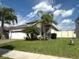 Charming single Gathering home with a stone facade, well manicured lawn, and beautiful landscaping at 384 Summer Squall Rd, Davenport, FL 33837