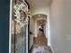 Welcoming foyer with a decorative wreath on the front door, arched doorways, and a long, inviting hallway at 384 Summer Squall Rd, Davenport, FL 33837