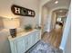 Inviting entryway with a stylish console table, modern lamp, decorative rug, and doorway leading to the living area at 384 Summer Squall Rd, Davenport, FL 33837