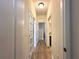 Bright hallway with wood flooring and white doors, offering a clean and spacious feel at 384 Summer Squall Rd, Davenport, FL 33837