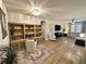 Bright living room features a built-in desk, modern lighting and hardwood flooring at 384 Summer Squall Rd, Davenport, FL 33837