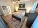 Main bedroom with hardwood floors, ceiling fan, natural light, neutral decor and carpet at 384 Summer Squall Rd, Davenport, FL 33837