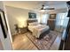 Main bedroom with hardwood floors, ceiling fan, natural light, neutral decor and carpet at 384 Summer Squall Rd, Davenport, FL 33837