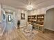 Home office featuring a built-in desk, ample storage, stylish decor, hardwood floors, and a crystal chandelier at 384 Summer Squall Rd, Davenport, FL 33837