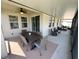 A covered patio with a dining area and a separate seating area at 384 Summer Squall Rd, Davenport, FL 33837