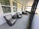 A relaxing screened-in patio area is furnished with comfortable seating at 384 Summer Squall Rd, Davenport, FL 33837