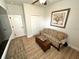 Comfortable sitting room with a floral sofa, wooden floors, and ample natural light at 384 Summer Squall Rd, Davenport, FL 33837