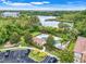 An aerial view shows a community pool, lounge chairs, parking spaces, and lush landscaping overlooking a pond at 4814 Luge Ln, Orlando, FL 32839