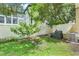 Spacious backyard featuring mature trees and a white fence, offering a private outdoor retreat at 4814 Luge Ln, Orlando, FL 32839