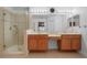 Bathroom featuring double vanity, glass shower, tile flooring, and framed mirror at 4814 Luge Ln, Orlando, FL 32839