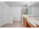 Bright bathroom featuring a glass-enclosed shower, double sink vanity, and neutral tile flooring at 4814 Luge Ln, Orlando, FL 32839