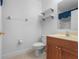 Bathroom with a wood vanity, sink, toilet, shelving and neutral paint at 4814 Luge Ln, Orlando, FL 32839