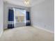 Comfortable bedroom with a ceiling fan, carpet flooring, and a bright window with nice curtains at 4814 Luge Ln, Orlando, FL 32839