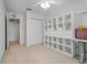 A functional bedroom with a ceiling fan, shelving, and closet at 4814 Luge Ln, Orlando, FL 32839