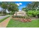 Welcome to Millennium Parc, a beautifully landscaped community entrance with vibrant flowerbeds at 4814 Luge Ln, Orlando, FL 32839
