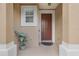 Inviting entryway with a neutral color palette, decorative plant, and a classic front door at 4814 Luge Ln, Orlando, FL 32839