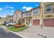 Well-maintained townhome exterior with manicured landscaping, garages, and brick paver driveways, plus street parking at 4814 Luge Ln, Orlando, FL 32839