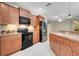 Bright kitchen with stainless steel appliances, tile flooring, and wood cabinets at 4814 Luge Ln, Orlando, FL 32839