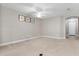Spacious living room with neutral carpet, a ceiling fan, and an arched doorway at 4814 Luge Ln, Orlando, FL 32839