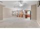 Bright, open floor plan with neutral walls, plush carpeting, and seamless flow between living areas at 4814 Luge Ln, Orlando, FL 32839