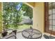 Cozy outdoor patio featuring a table, chairs, and green plants at 4814 Luge Ln, Orlando, FL 32839