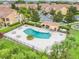 Community pool surrounded by lounge chairs, mature trees and a covered patio in a gated community at 4814 Luge Ln, Orlando, FL 32839