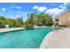 Community pool area with inviting blue water, lounge chairs, and well-kept landscaping at 4814 Luge Ln, Orlando, FL 32839