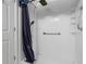 Clean shower stall featuring a shower curtain, shower head, and grab bar at 4814 Luge Ln, Orlando, FL 32839