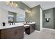 Modern bathroom featuring a double vanity, a large mirror and a walk-in shower at 5177 Blanket Flower St, Apopka, FL 32712