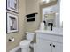 Bathroom with white vanity and fixtures, a black towel bar, and framed art at 5177 Blanket Flower St, Apopka, FL 32712