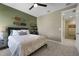 Bedroom showcasing neutral tones, carpet floors, skateboard wall decor and a doorway to another room at 5177 Blanket Flower St, Apopka, FL 32712
