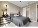 Cozy bedroom features a comfortable bed, stylish nightstand, and closet with sliding doors at 5177 Blanket Flower St, Apopka, FL 32712